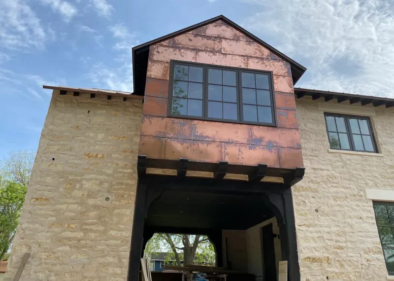 Copper metal panel facade on a stone building for Metal Roof Coating in Solon